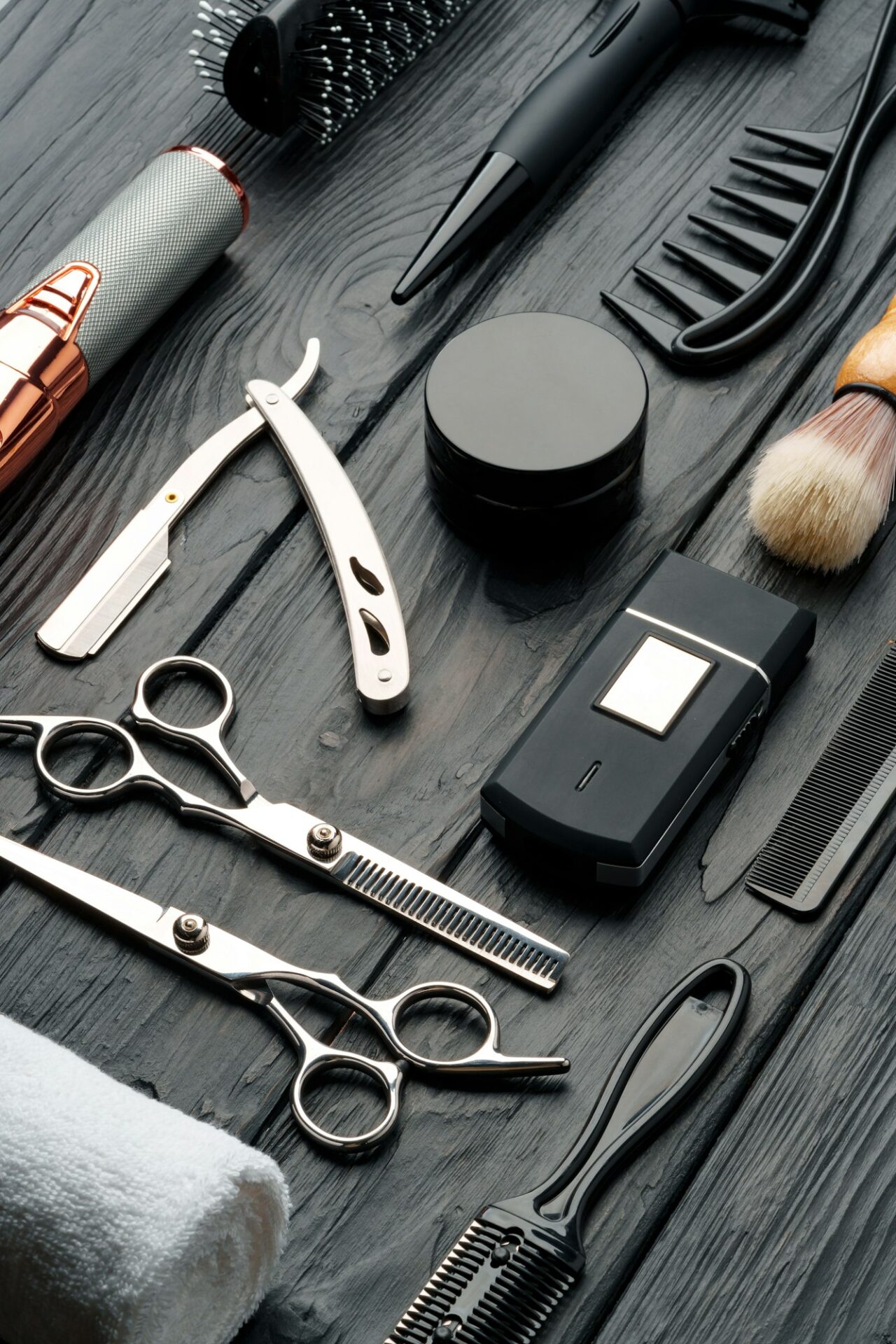 Professional Barber Tools Laid Out on Dark Wooden Surface