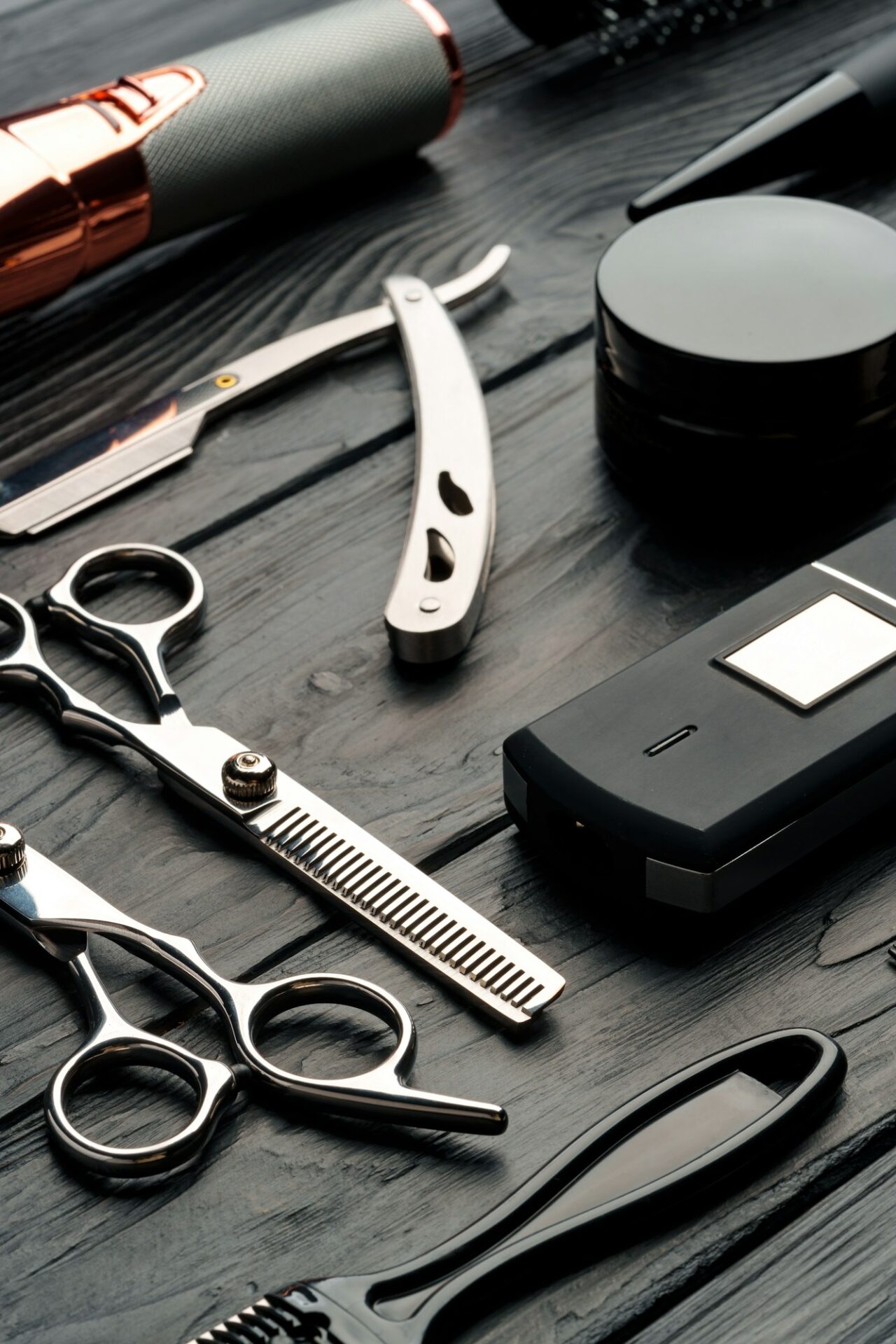 Professional Barber Tools Laid Out on Dark Wooden Surface